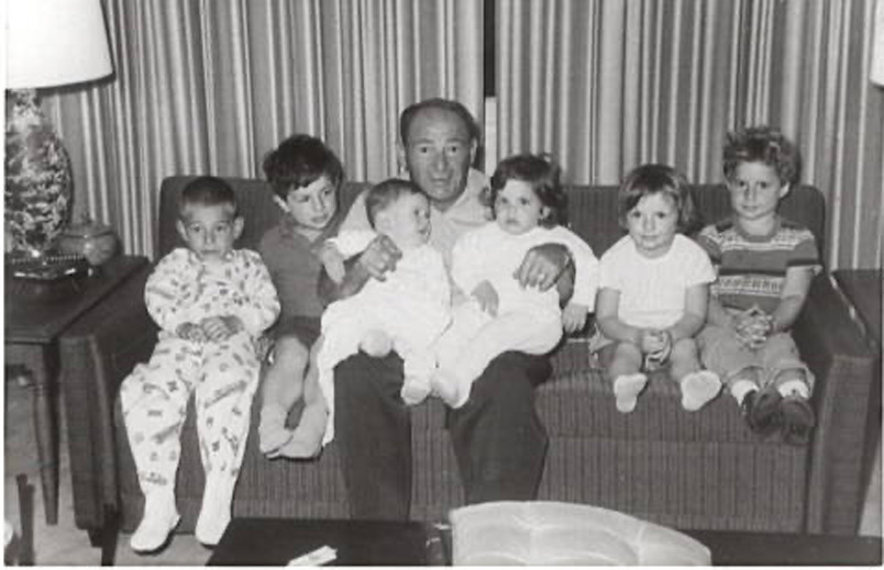 Black and white photo of kids Eric and Linda with family members on a couch in Palm Springs
